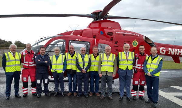 Members of the Tyrone and Fermanagh Masonic Welfare Fund posing with air crew alongside the AC 135 helicopter